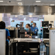 TSA agents work at a security checkpoint at the Ronald Reagan National Airport on July 22, 2020 in Arlington, Virginia. During the COVID-19 pandemic, all employees and passengers are required to wear facemasks while onboard a Delta plane
